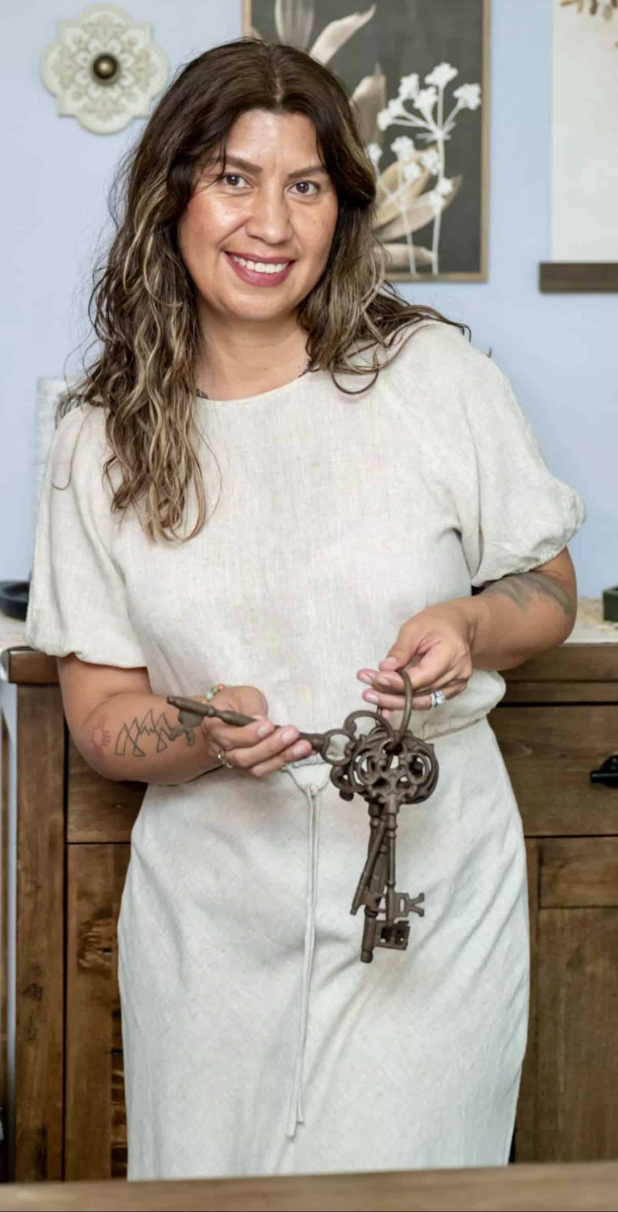 Jennifer Lisa Way holding antique keys, with the original photographic background intact